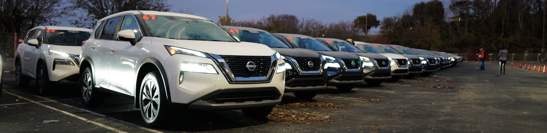 A row of numbered white and dark SUVs staged in a parking lot for the MegaVanderTest